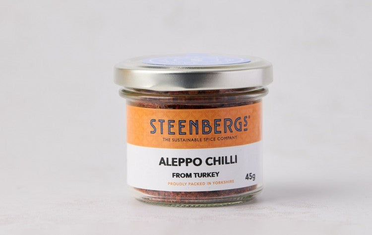 Steenbergs organic Aleppo chilli flakes in a recyclable glass jar with a white and orange label