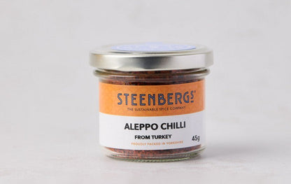 Steenbergs organic Aleppo chilli flakes in a recyclable glass jar with a white and orange label