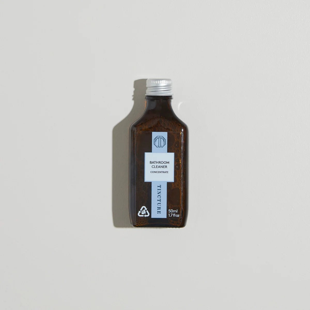 Tincture London 50ml concentrated bathroom cleaner refill in a small amber glass bottle with a silver cap