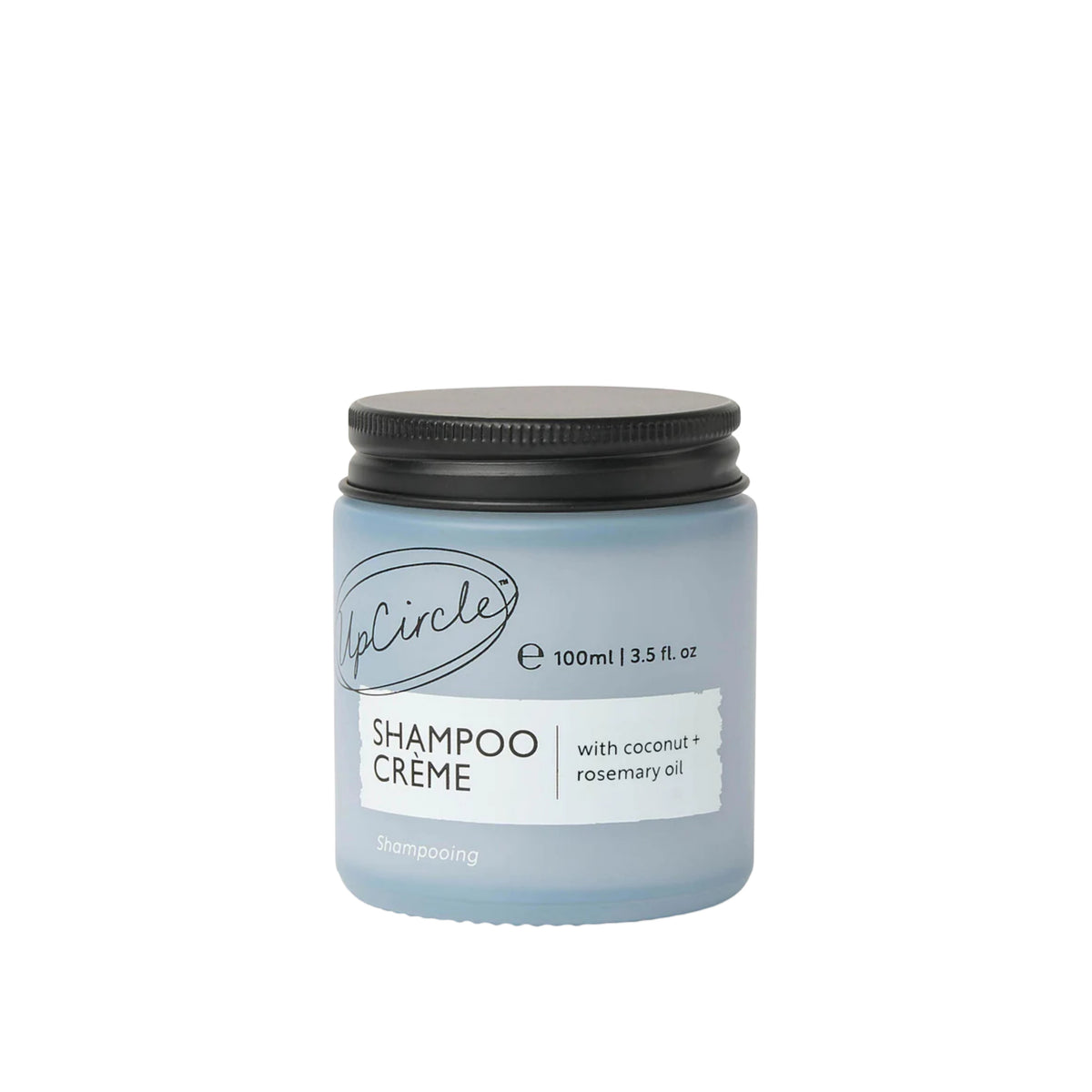 UpCircle shampoo crème in a frosted glass jar with a black lid, featuring coconut and rosemary oil formula.