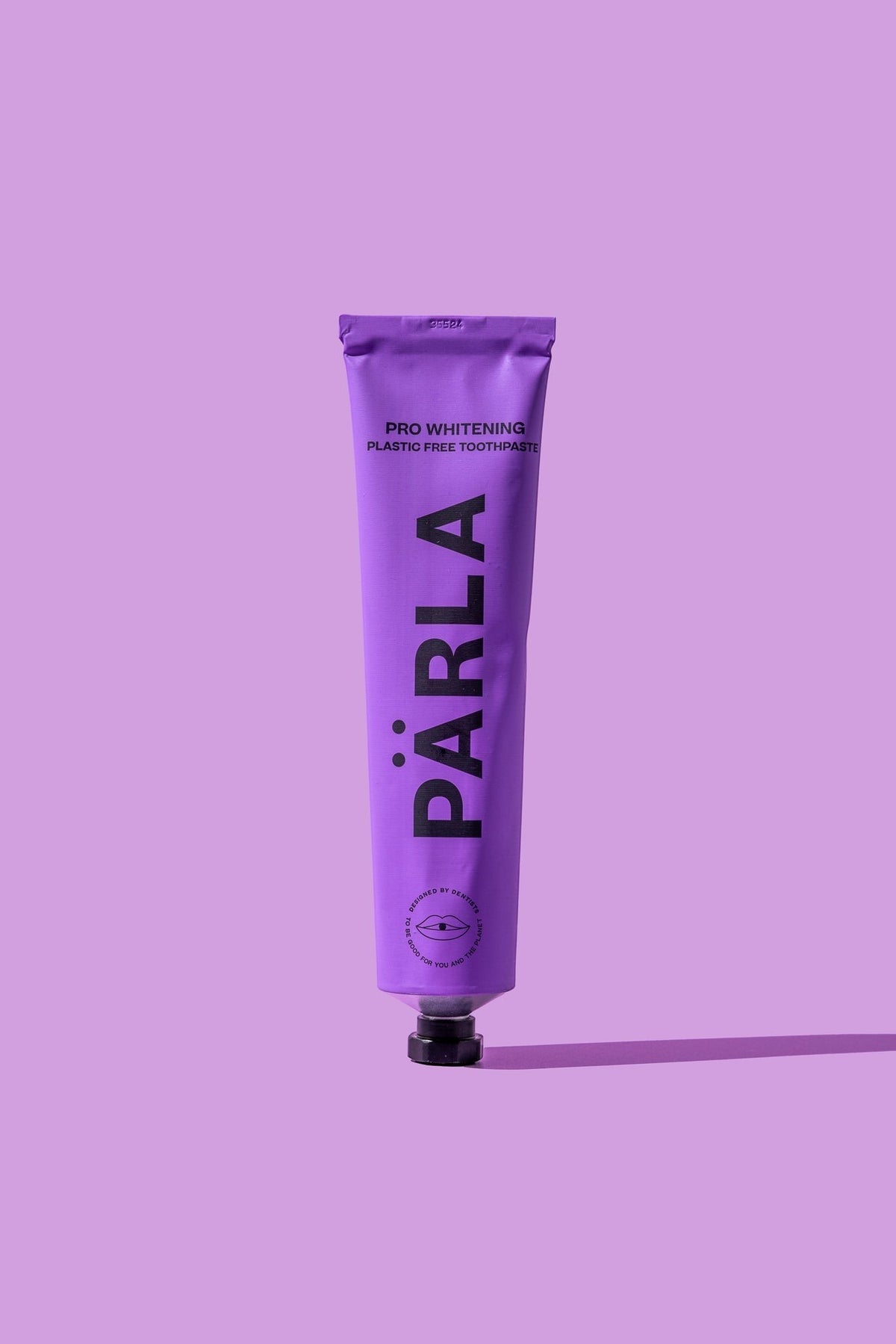 Pärla whitening toothpaste in a purple tube with black text, designed for enamel health and stain removal.