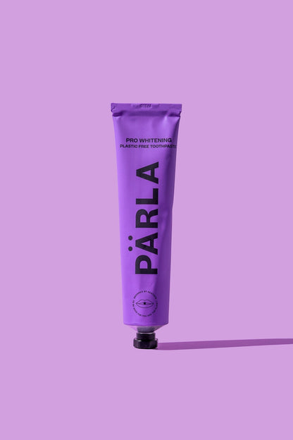 Pärla whitening toothpaste in a purple tube with black text, designed for enamel health and stain removal.
