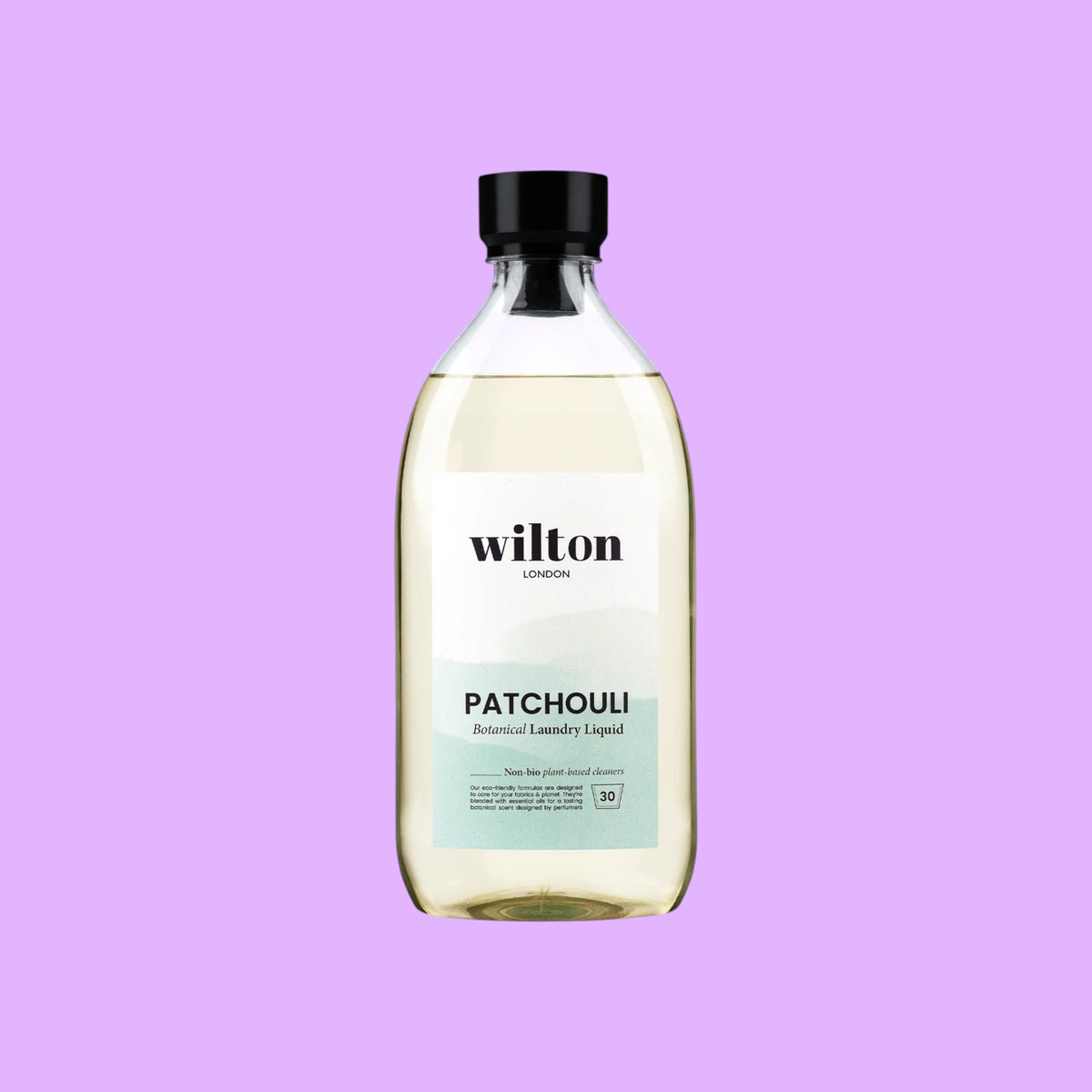 Wilton London Patchouli non-bio laundry liquid in a clear 1.05L bottle with a black cap on a light background, shown from a different angle.