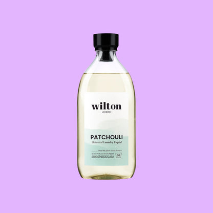 Wilton London Patchouli non-bio laundry liquid in a clear 1.05L bottle with a black cap on a light background, shown from a different angle.
