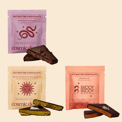 Cosmic Dealer gift box featuring three assorted nut butter dark chocolate squares with unique botanical designs.