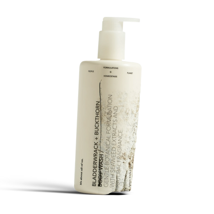 dulcie Bladderwrack and Buckthorn body wash in a 500ml white pump bottle with minimalist botanical label design, close-up detail shot.