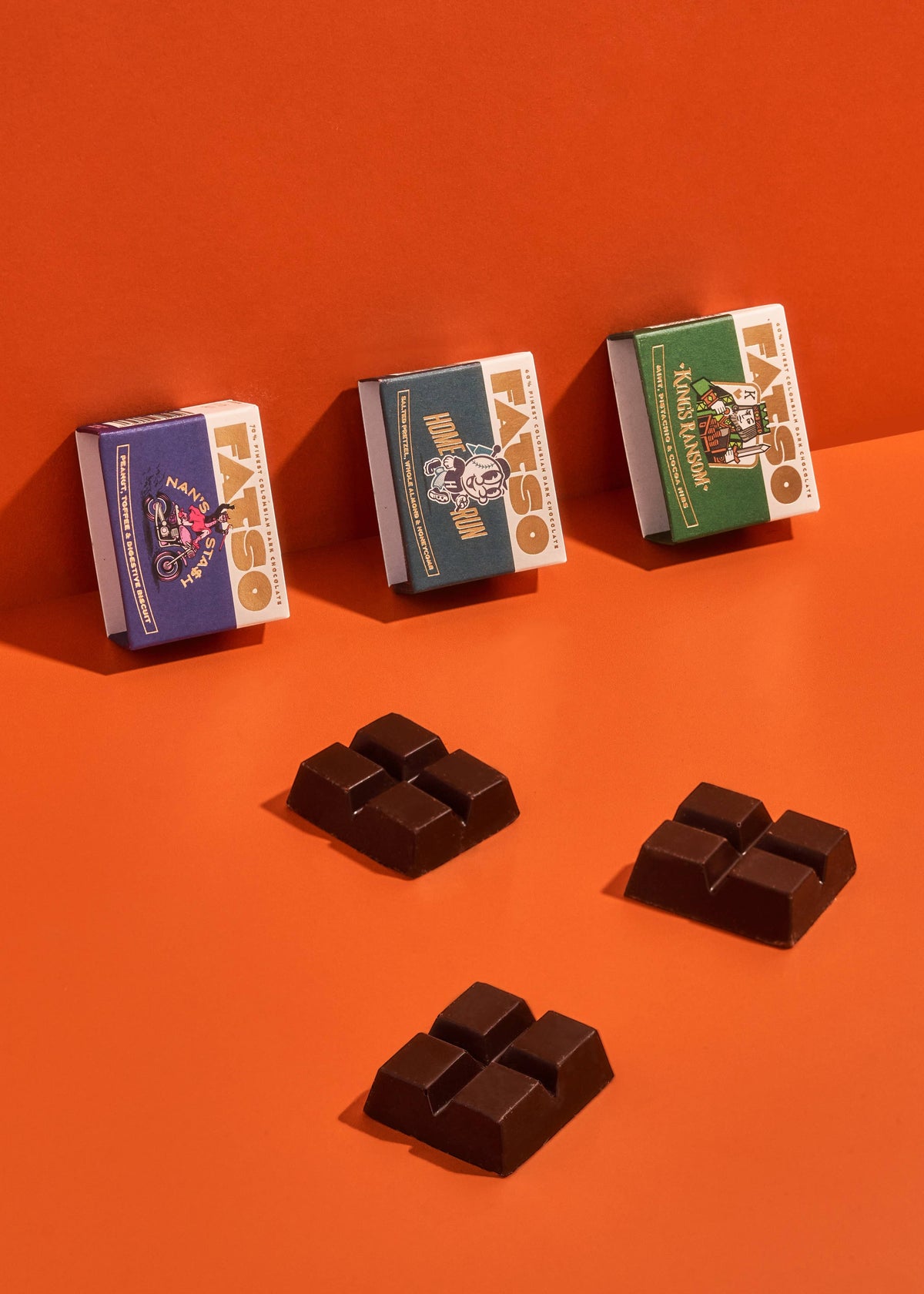 FATSO Mini Home Run dark chocolate bar with salted pretzels, almonds, and honeycomb on an orange background