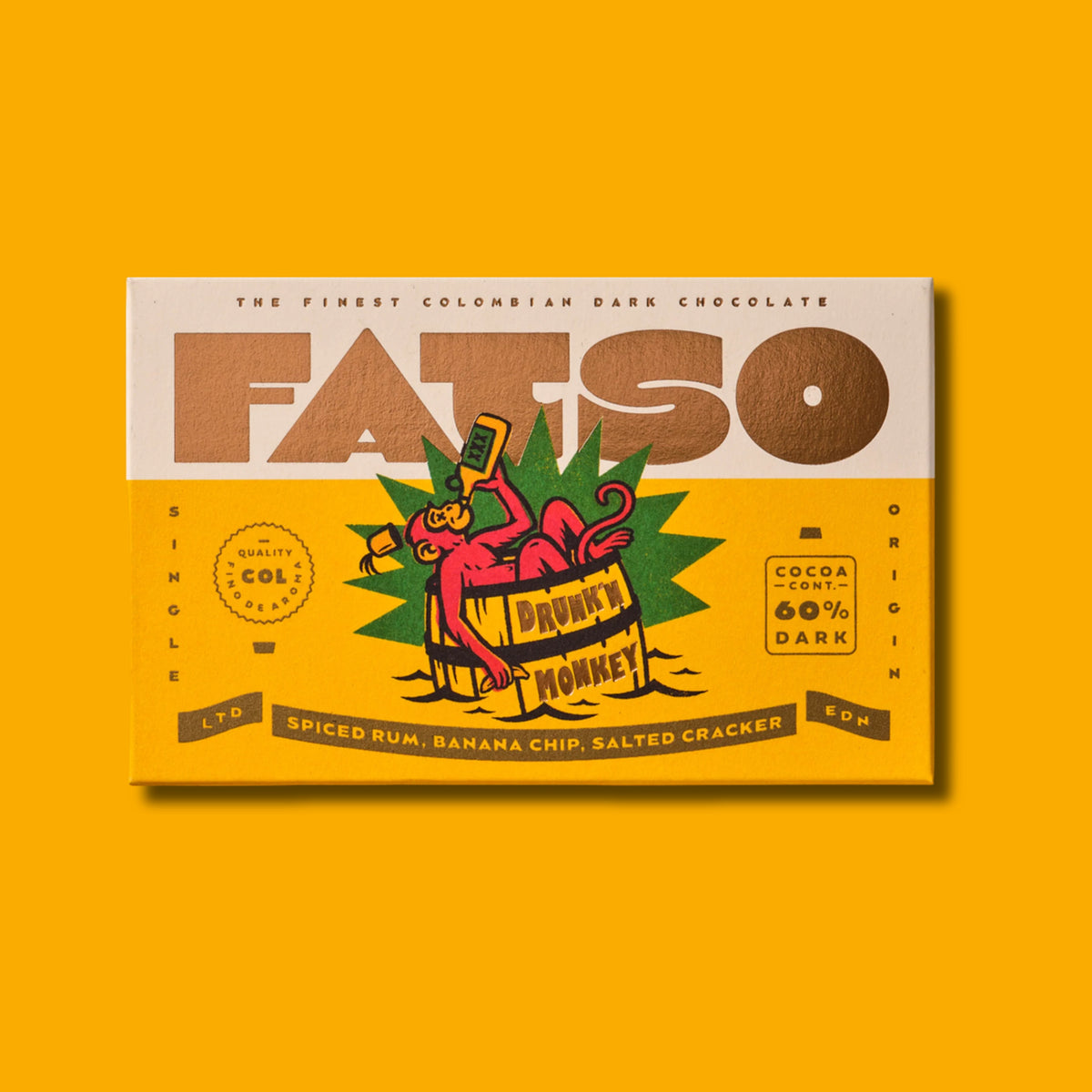 FATSO Drunk'n Monkey 60% dark chocolate bar with spiced rum, banana chips, and salted cracker on yellow background