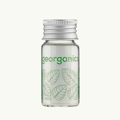 georganics spearmint dental floss in a refillable glass dispenser with an aluminium lid and green leaf print