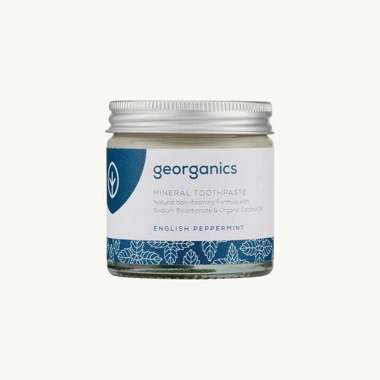 Georganics natural peppermint mineral toothpaste in a glass jar with an aluminium lid and blue label