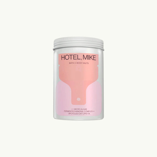 Hotel Mike Bath and Body Salts in a recyclable jar with pink label featuring micro algae and upcycled oat lipid oil