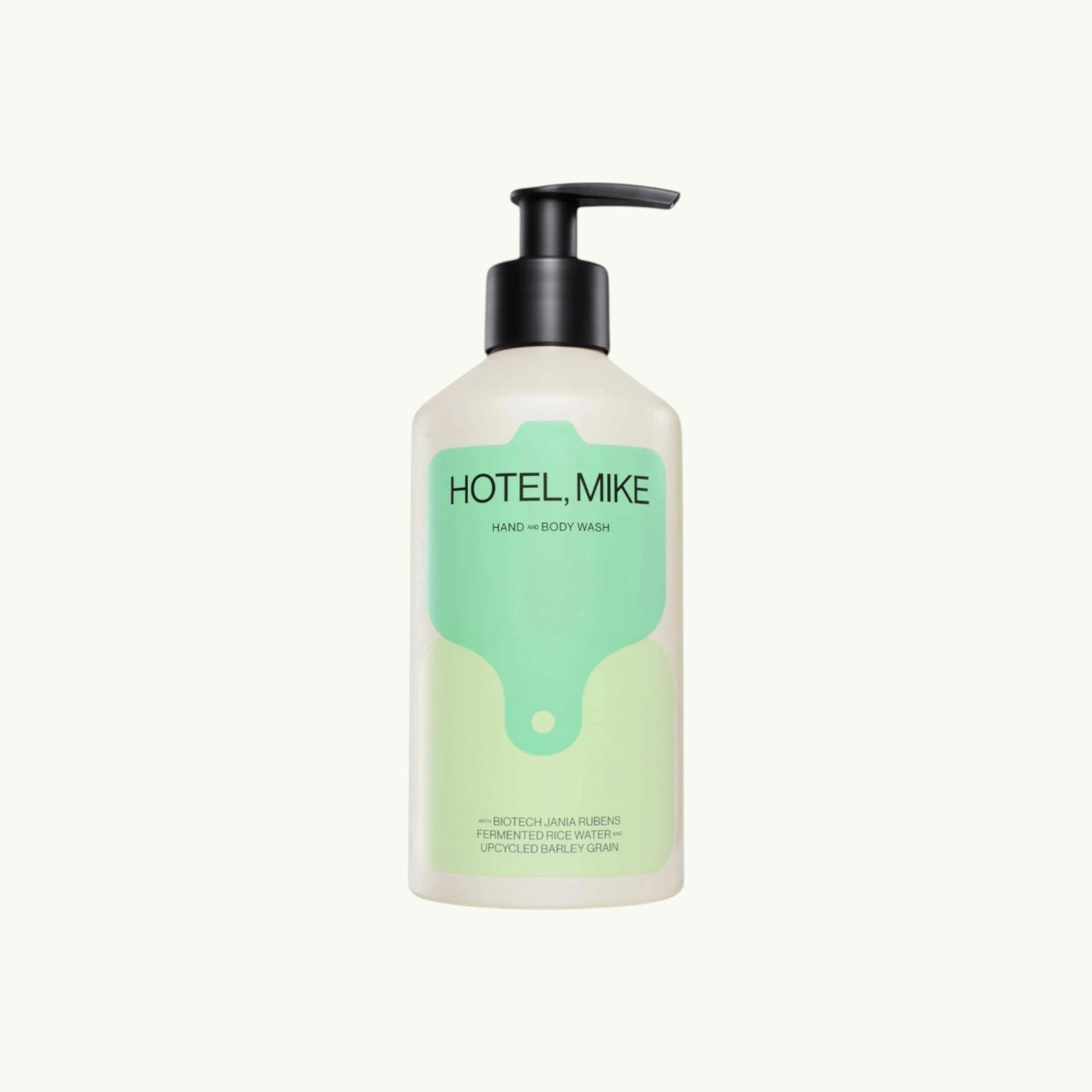 Hotel Mike Hand & Body Wash in a recyclable aluminium bottle with a black pump dispenser and minimalist green label.