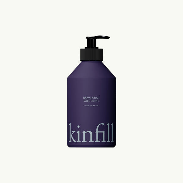 Kinfill Wild Peony body lotion in a dark purple refillable bottle with a black pump dispenser.