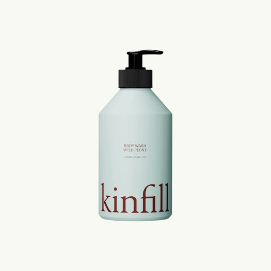Kinfill Wild Peony body wash in a refillable light blue aluminium bottle with a black pump dispenser.
