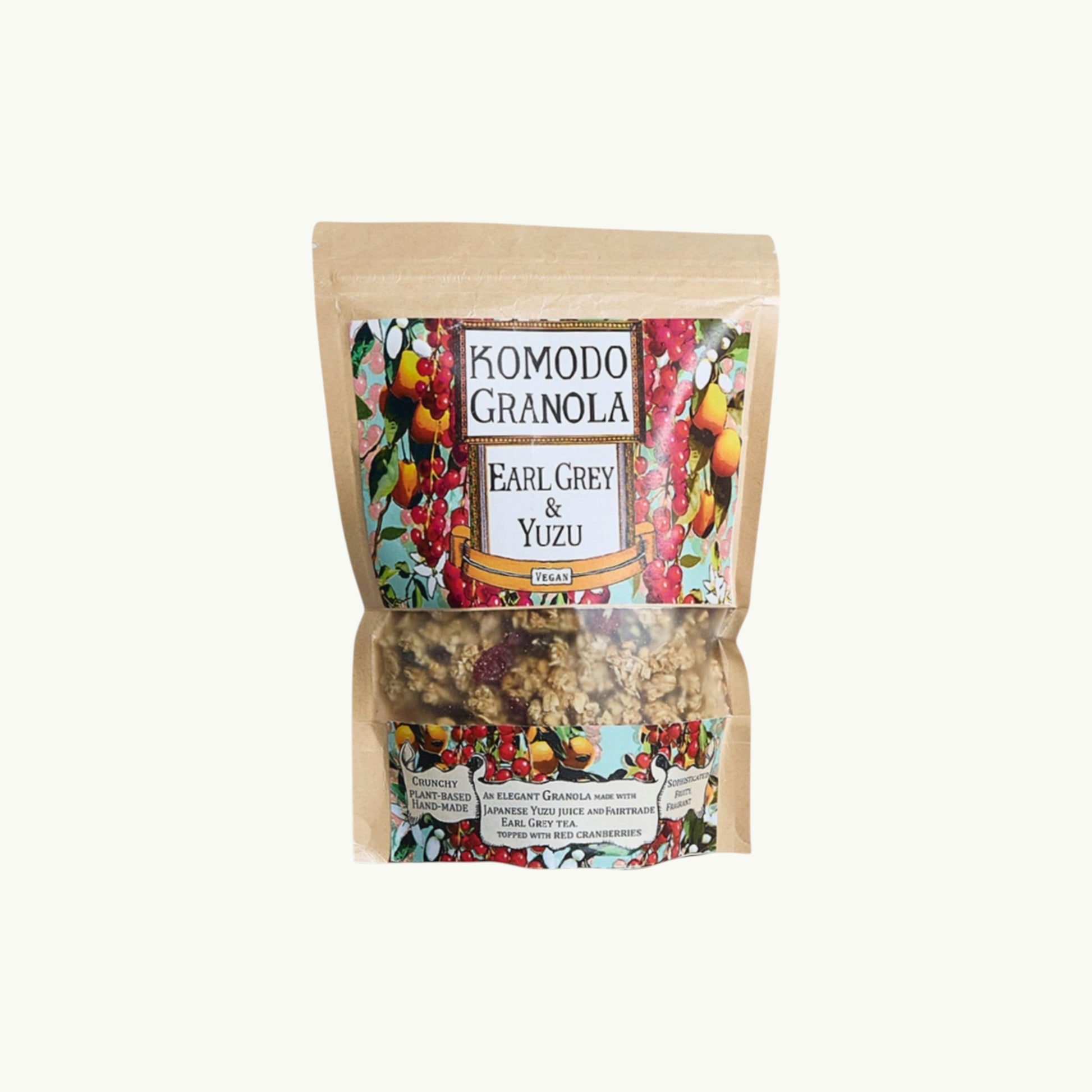 Komodo Bakery Earl Grey and Yuzu granola in a clear window pouch with vibrant botanical label art.
