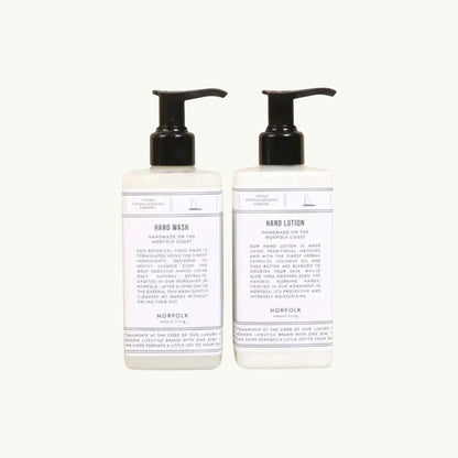 Norfolk Natural Living Coastal Walks hand wash and lotion set in white bottles with black pumps, featuring botanical ingredients.