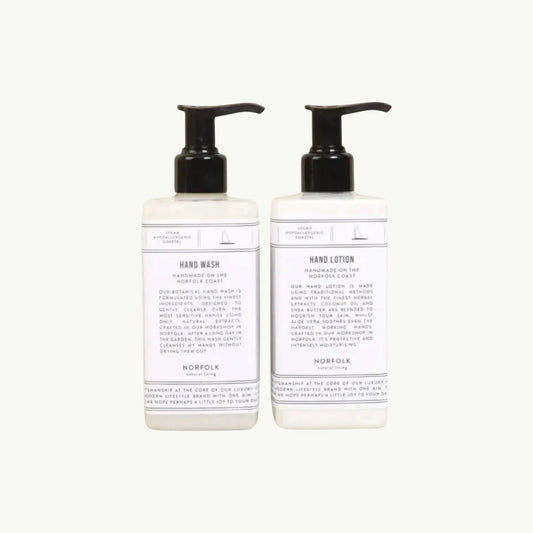 Norfolk Natural Living Coastal Walks hand wash and lotion set in white bottles with black pumps, featuring botanical ingredients.