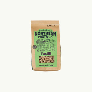 Northern Pasta Co. fusilli in a brown paper bag with a window showing the spiral spelt pasta inside.