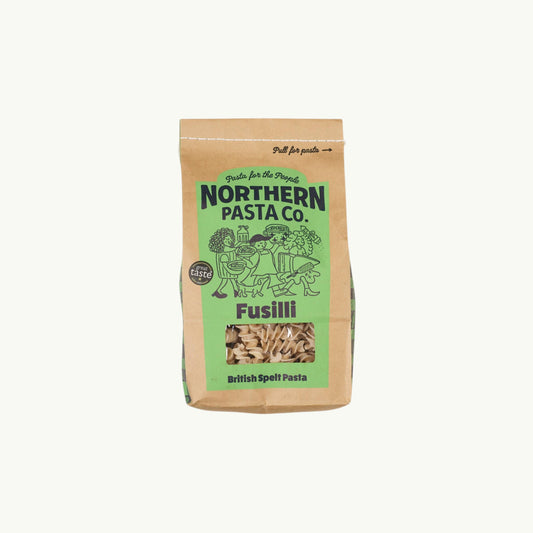 Northern Pasta Co. fusilli in a brown paper bag with a window showing the spiral spelt pasta inside.