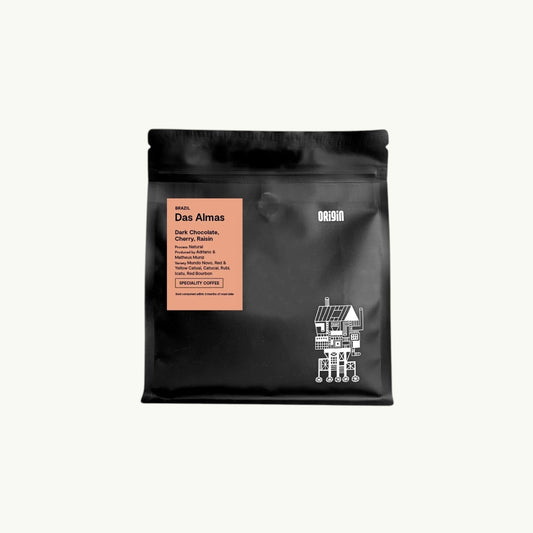 Origin Coffee Das Almas whole bean coffee in a black 250g bag with a peach label featuring tasting notes of chocolate