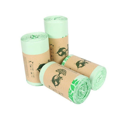Re:gn biodegradable cornstarch bin bags in light green, rolled with eco-friendly paper labels on a white background.