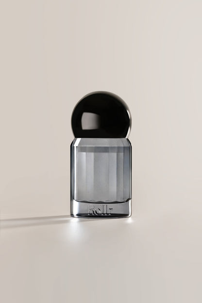 Rollr refillable glass roll-on deodorant bottle with a sleek dark grey finish and black cap
