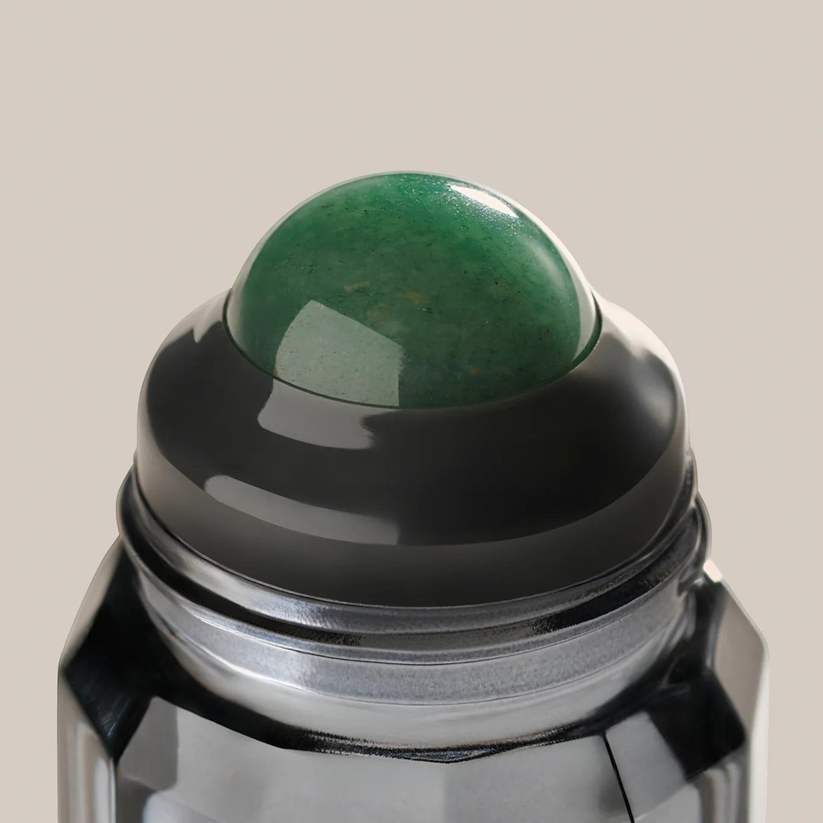 rollr refillable roll-on deodorant featuring a smooth green aventurine stone roller ball in a sleek glass bottle