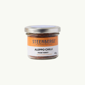 Steenbergs organic Aleppo chilli flakes in a recyclable glass jar, a mild Turkish spice for Mediterranean dishes.