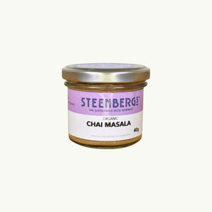 Steenbergs organic masala chai spice blend in a small recyclable glass jar with a purple label