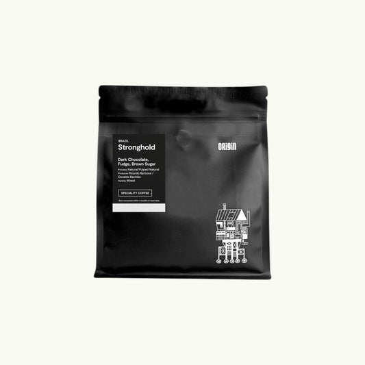 Origin Coffee Stronghold whole bean coffee in a matte black resealable bag with white label and graphic illustration