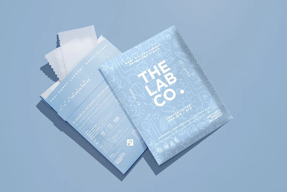 The Lab Co. soothing laundry detergent strips in light blue plastic-free packaging with white line art details.