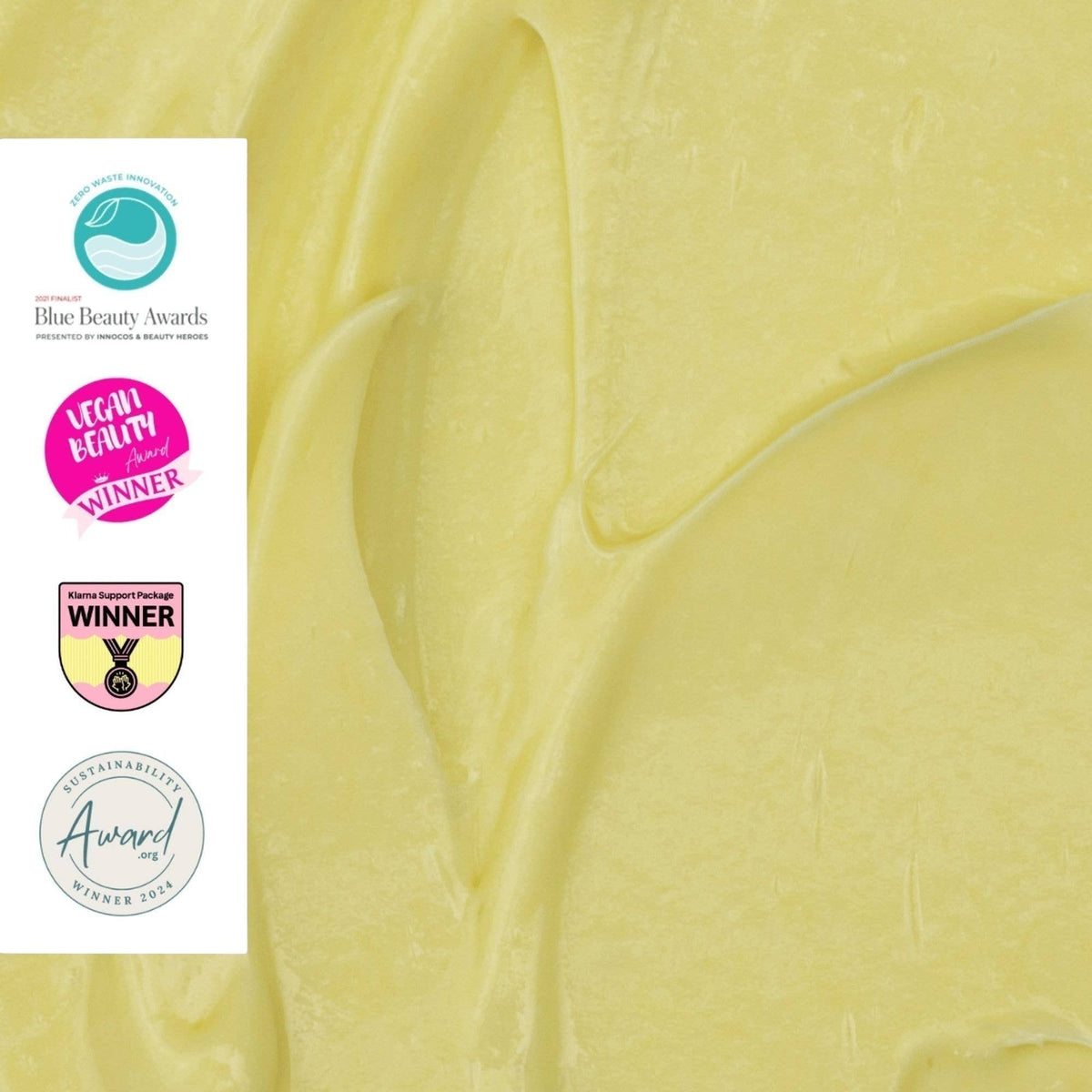 upcircle anti-ageing night cream texture showing a rich, pale yellow cream with award-winning sustainability badges.