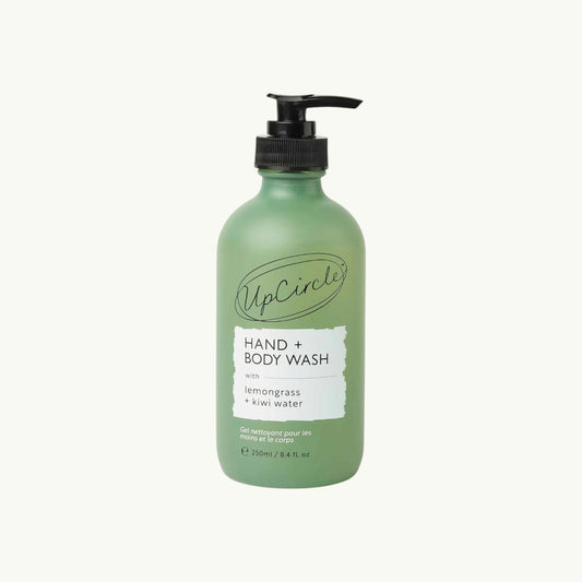 BRiMM Hand & Body Wash in a frosted green glass bottle with a black pump, featuring lemongrass and kiwi fruit water.