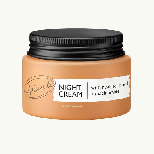 upcircle anti-ageing night cream in a terracotta jar with black lid, featuring hyaluronic acid and niacinamide.