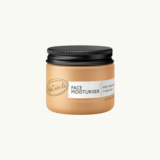 upcircle face moisturiser in a glass jar with a black aluminium lid, featuring vitamin E and aloe vera.