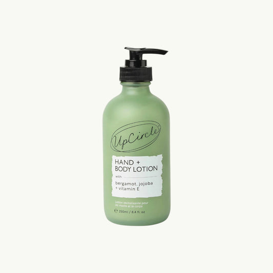 BRiMM hand and body lotion in a frosted green glass bottle with a black pump dispenser and bergamot scent label