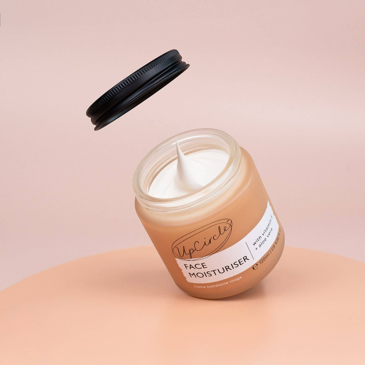 upcircle face moisturiser with vitamin E and aloe vera in a glass jar with a floating black aluminium lid