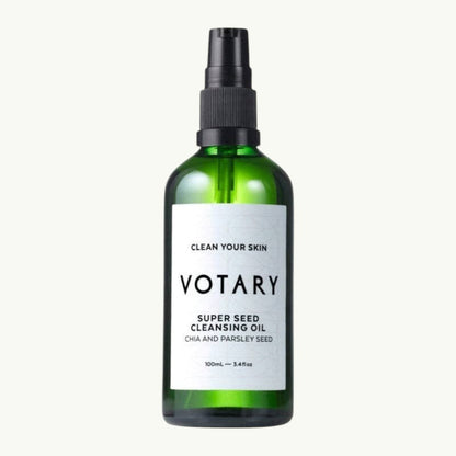 VOTARY Super Seed Cleansing Oil in a green glass bottle with a black pump dispenser for facial skincare