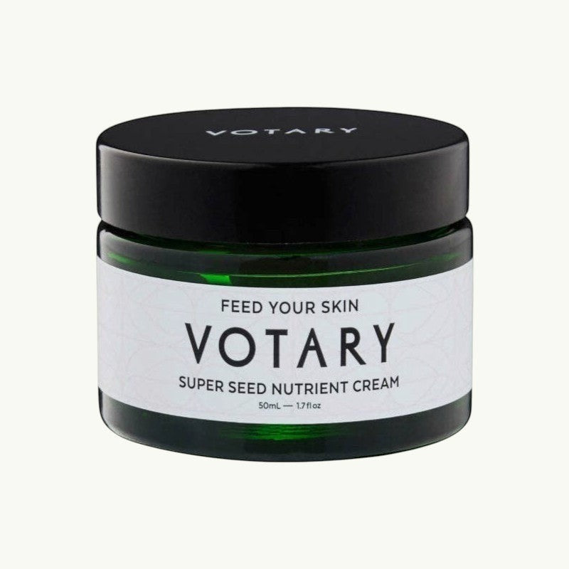 Votary Super Seed Nutrient Cream in a dark green glass jar with a black lid for hydrating and antioxidant skincare.