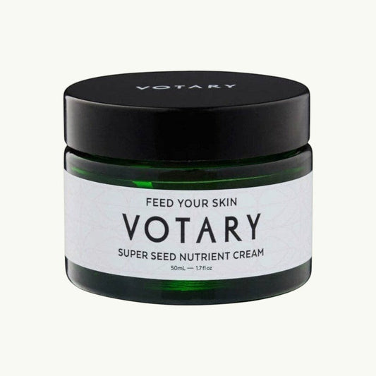 Votary Super Seed Nutrient Cream in a dark green glass jar with a black lid for hydrating and antioxidant skincare.