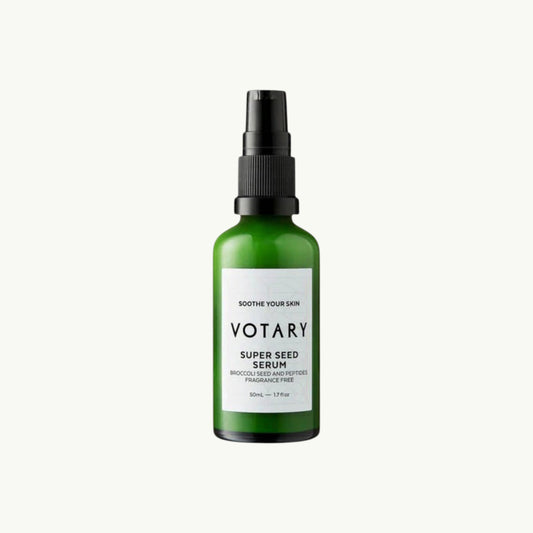 Votary Super Seed Serum in a green glass bottle with a black pump, designed to soothe and hydrate sensitive skin.