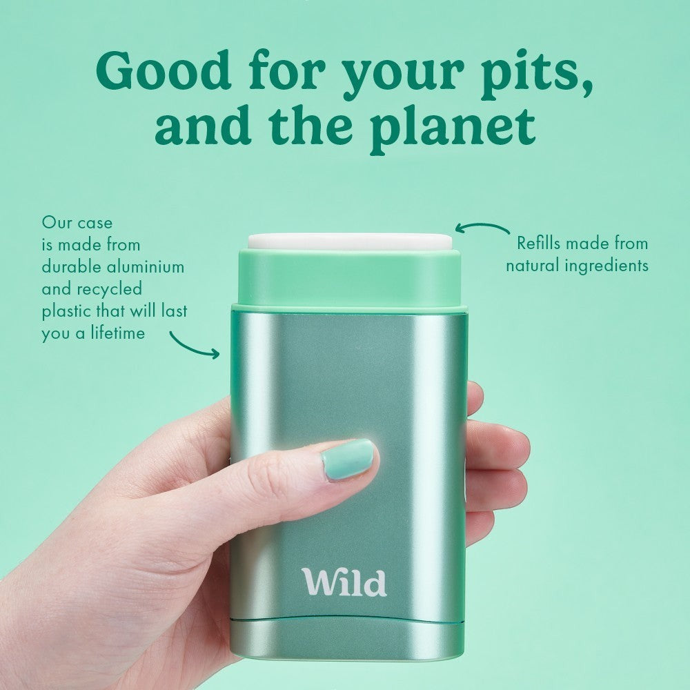 Wild refillable deodorant in a mint green aluminium case held in a hand against a matching green background.