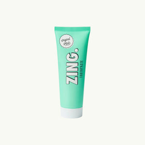 Zing mint enamel whitening toothpaste in a light green tube with a white cap, vegan and cruelty-free formula.